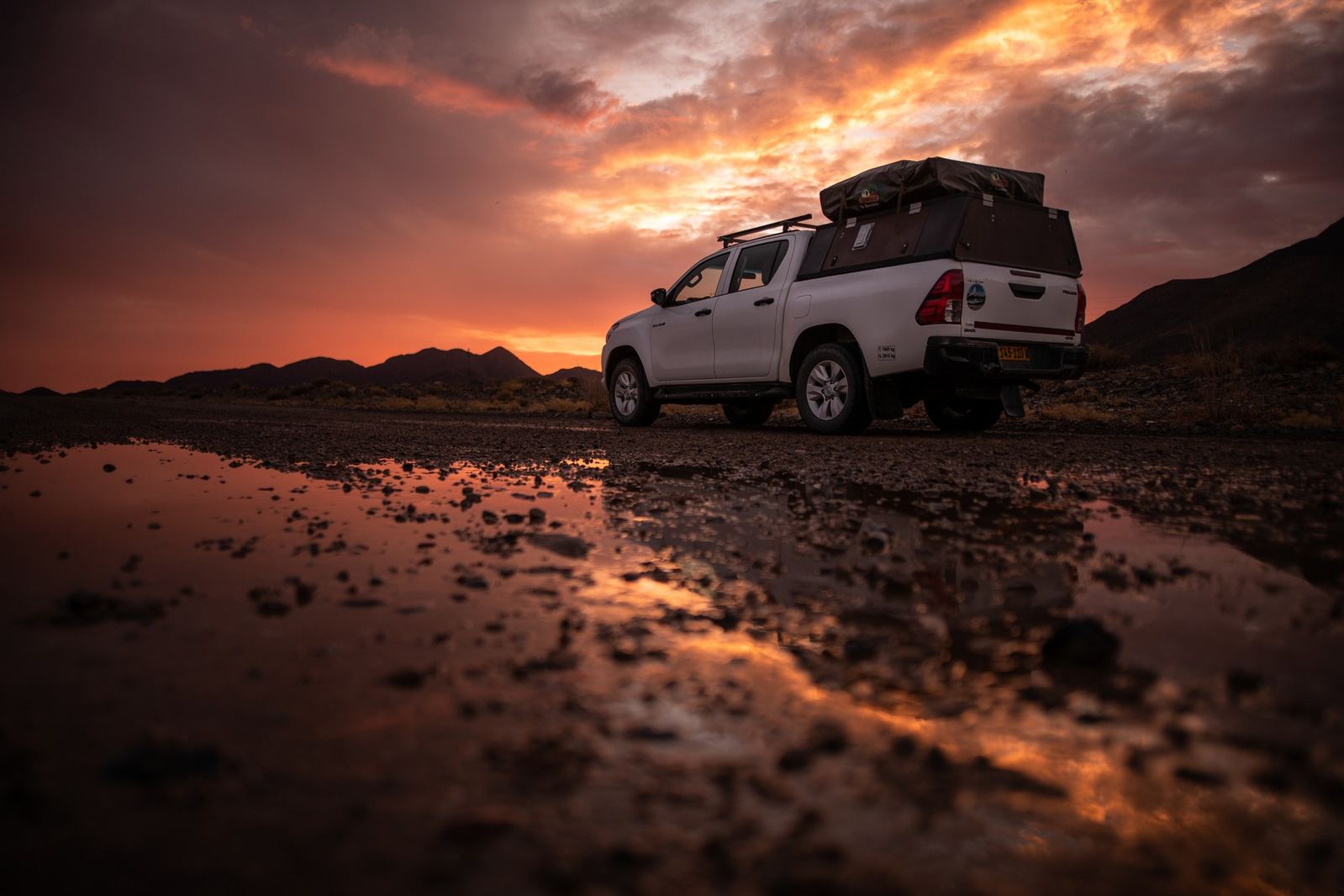 A Herd Namibia Toyota Hilux with rooftop tent at sunset